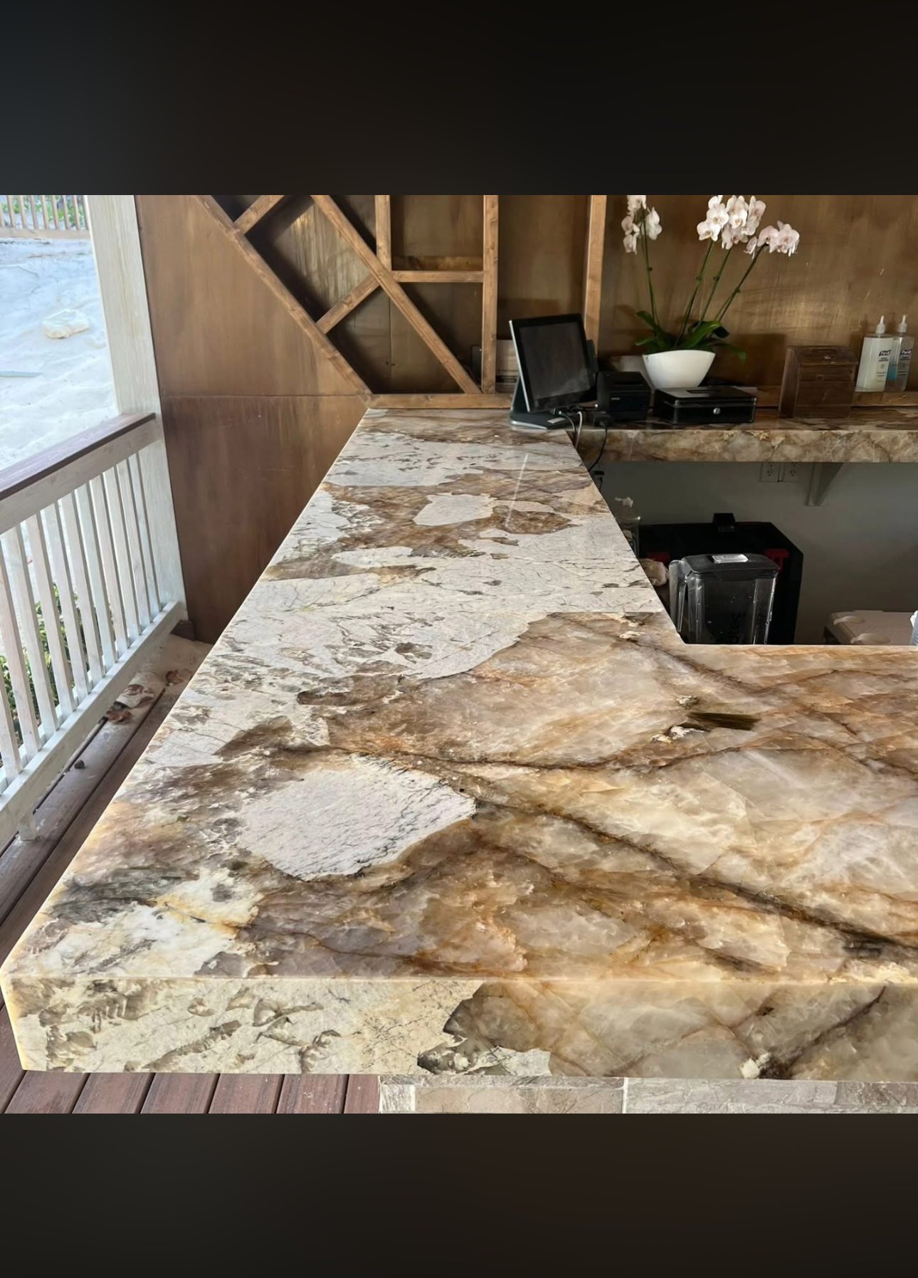 Natural stone bar top with the veining matched across the run